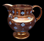 Overall copper luster jug with painted blue flowers - private collection.